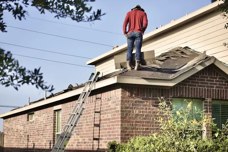 Professional roofer working on a residential roof in Hicksville
